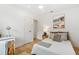 A bright bedroom features a bed and desk, with modern decor and lots of light at 2189 Hillview St, Sarasota, FL 34239