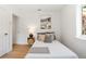 A bright bedroom features a bed and desk, with modern decor and lots of light at 2189 Hillview St, Sarasota, FL 34239