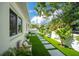 Home with manicured lawn, stepping stone path, and white privacy fence at 2189 Hillview St, Sarasota, FL 34239