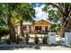 Beautiful white home with desert landscaping, palm trees, and a cozy egg chair at 2189 Hillview St, Sarasota, FL 34239