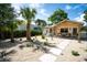 Attractive home with desert landscaping, a cozy hanging chair, and mature palm trees at 2189 Hillview St, Sarasota, FL 34239