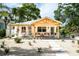 Inviting home with a charming porch, outdoor seating, a hanging chair, and minimalist landscaping at 2189 Hillview St, Sarasota, FL 34239