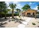 Beautifully landscaped front yard leading to a charming home with a cozy porch and outdoor seating at 2189 Hillview St, Sarasota, FL 34239