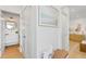 Bright hallway with modern furnishings and decor leading to a bedroom and bathroom at 2189 Hillview St, Sarasota, FL 34239