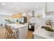 Modern kitchen with white cabinetry, stainless steel appliances, pendant lighting, and an island with bar seating at 2189 Hillview St, Sarasota, FL 34239