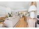 Open floor plan showcasing the living room and kitchen with light wood floors and beachy design elements at 2189 Hillview St, Sarasota, FL 34239