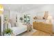 Bright bedroom with a modern ceiling fan, a wooden dresser and sliding glass doors to the exterior at 2189 Hillview St, Sarasota, FL 34239