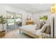 Bright bedroom with a modern ceiling fan, a wooden dresser and sliding glass doors to the exterior at 2189 Hillview St, Sarasota, FL 34239
