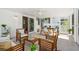 Inviting screened porch with comfortable seating, dining table, and ceiling fan at 2189 Hillview St, Sarasota, FL 34239