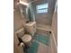 Bathroom featuring a shower over tub, toilet, vanity, and marble style tile walls at 22214 Felton Ave, Port Charlotte, FL 33952
