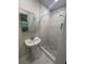 Updated bathroom features white marble floors, modern sink, updated fixtures, and stand up shower at 22214 Felton Ave, Port Charlotte, FL 33952
