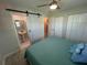 Bedroom has a sliding barn door leading to ensuite bathroom, plus hallway door, closets, and fan at 22214 Felton Ave, Port Charlotte, FL 33952