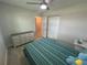 Bedroom featuring a full bed, ceiling fan, closet, and wooden floors at 22214 Felton Ave, Port Charlotte, FL 33952