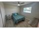 Bright bedroom featuring a twin bed with striped quilt, ceiling fan, and a window at 22214 Felton Ave, Port Charlotte, FL 33952
