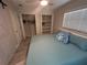 Bedroom with large closets for storage, a window providing natural light and wood-look floors at 22214 Felton Ave, Port Charlotte, FL 33952