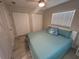 Bright bedroom features two double door closets, ceiling fan, a window, and wood-look floors at 22214 Felton Ave, Port Charlotte, FL 33952