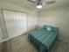 Bedroom featuring a bed, ceiling fan, large closet, and wooden floors at 22214 Felton Ave, Port Charlotte, FL 33952