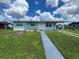 Charming single story home with a well-maintained lawn and inviting front entrance at 22214 Felton Ave, Port Charlotte, FL 33952