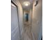Hallway with updated gray wood-look flooring leading to rooms with white doors, and neutral wall paint at 22214 Felton Ave, Port Charlotte, FL 33952