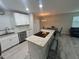 Modern kitchen featuring granite countertops, white cabinets, and stainless-steel appliances at 22214 Felton Ave, Port Charlotte, FL 33952