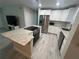Bright kitchen features granite counters, stainless appliances, white cabinets and updated gray wood-look flooring at 22214 Felton Ave, Port Charlotte, FL 33952