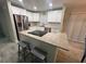 Modern kitchen with white cabinets, stainless steel appliances, granite countertops and a central island at 22214 Felton Ave, Port Charlotte, FL 33952