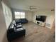 The spacious living room features neutral walls, light colored floors and bright natural light at 22214 Felton Ave, Port Charlotte, FL 33952