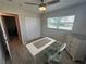 Office with hardwood floors, ceiling fan, desk, rolling chair, and a large window at 22214 Felton Ave, Port Charlotte, FL 33952