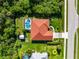 Aerial view of the home with a private screened-in pool, storage shed, and well-manicured landscaping at 22378 Peachland Blvd, Port Charlotte, FL 33954