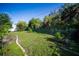 Spacious backyard featuring lush greenery, a storage shed, and a well-maintained lawn with established landscaping at 22378 Peachland Blvd, Port Charlotte, FL 33954
