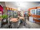 Bright dining room with seating for six, chandelier, and china cabinet storage on orange accent wall at 22378 Peachland Blvd, Port Charlotte, FL 33954