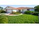 Charming single-story home with lush lawn and well-manicured landscaping at 22378 Peachland Blvd, Port Charlotte, FL 33954