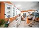Bright kitchen features white cabinetry, stainless steel appliances, breakfast bar, and an orange accent wall at 22378 Peachland Blvd, Port Charlotte, FL 33954