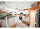 Bright eat-in kitchen with white cabinetry, tile floors, breakfast bar, and an orange accent wall at 22378 Peachland Blvd, Port Charlotte, FL 33954