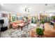 Inviting living room with tile floors, cozy seating, and an abundance of natural light from the windows at 22378 Peachland Blvd, Port Charlotte, FL 33954