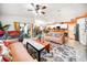 Inviting living room featuring an open layout, tile floors, and a ceiling fan with decorative furniture at 22378 Peachland Blvd, Port Charlotte, FL 33954