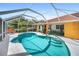 Lovely screened-in pool with poolside seating and convenient access to the home's vibrant colored living areas at 22378 Peachland Blvd, Port Charlotte, FL 33954