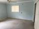 Empty bedroom featuring carpeting, a window, and a closet at 2451 Loma Linda St, Sarasota, FL 34239