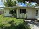 Rear view of a single-story home with a stucco exterior and a small yard at 2451 Loma Linda St, Sarasota, FL 34239