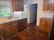 A kitchen features wood cabinets, stainless steel appliances, tile floors, and a window at 2451 Loma Linda St, Sarasota, FL 34239