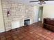 Spacious living room featuring tile flooring, a stone fireplace, and ample natural light at 2451 Loma Linda St, Sarasota, FL 34239