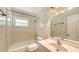 Bathroom featuring a tub, shower, sink, toilet, and tile walls at 2462 Hyde Park St, Sarasota, FL 34239