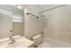 A bathroom with a bathtub, shower, sink, toilet, and large mirror at 2462 Hyde Park St, Sarasota, FL 34239
