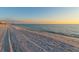 Beautiful beach view showcasing tranquil turquoise waters, white sands, and a serene sunset skyline at 2462 Hyde Park St, Sarasota, FL 34239