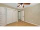 Bright bedroom featuring hardwood floors, a ceiling fan, and closet with sliding doors at 2462 Hyde Park St, Sarasota, FL 34239