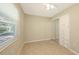 A neutral bedroom with a closet and tile floors, well-lit with a window at 2462 Hyde Park St, Sarasota, FL 34239