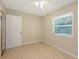 A simple bedroom featuring neutral colors, tile floors and natural light at 2462 Hyde Park St, Sarasota, FL 34239