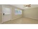 Comfortable room with tile floors, ceiling fan, and a large window providing natural light at 2462 Hyde Park St, Sarasota, FL 34239