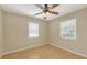 An airy bedroom featuring hardwood floors, ceiling fan and two large windows at 2462 Hyde Park St, Sarasota, FL 34239