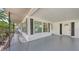 Inviting covered front porch with ample space, offering a cozy spot to relax and enjoy the neighborhood views at 2462 Hyde Park St, Sarasota, FL 34239
